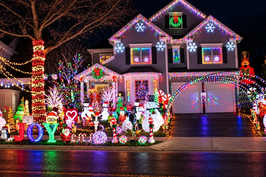 Full-color Christmas display with lit arches and yard decor